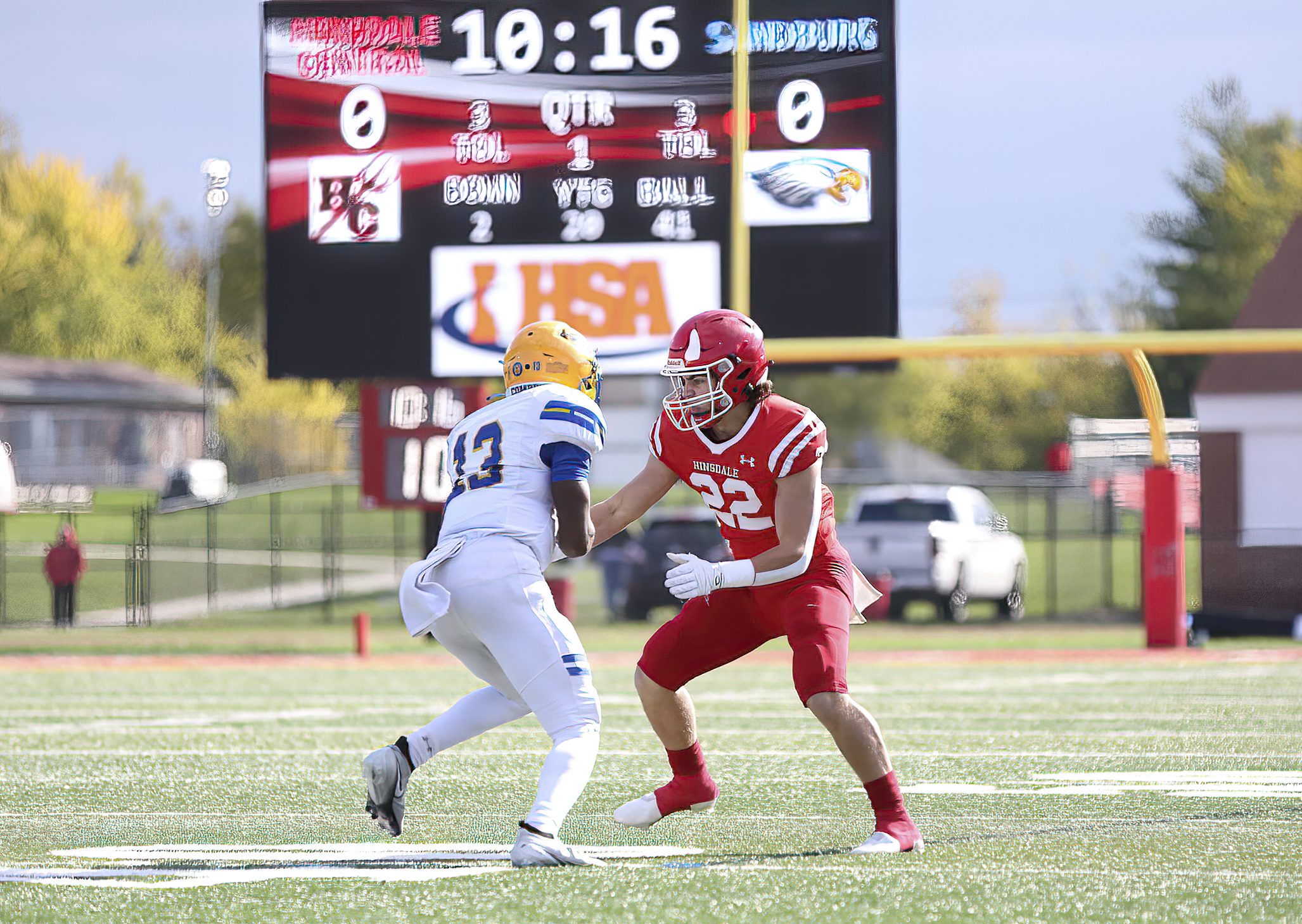 Young American football player preparing to tackle opponent on field.