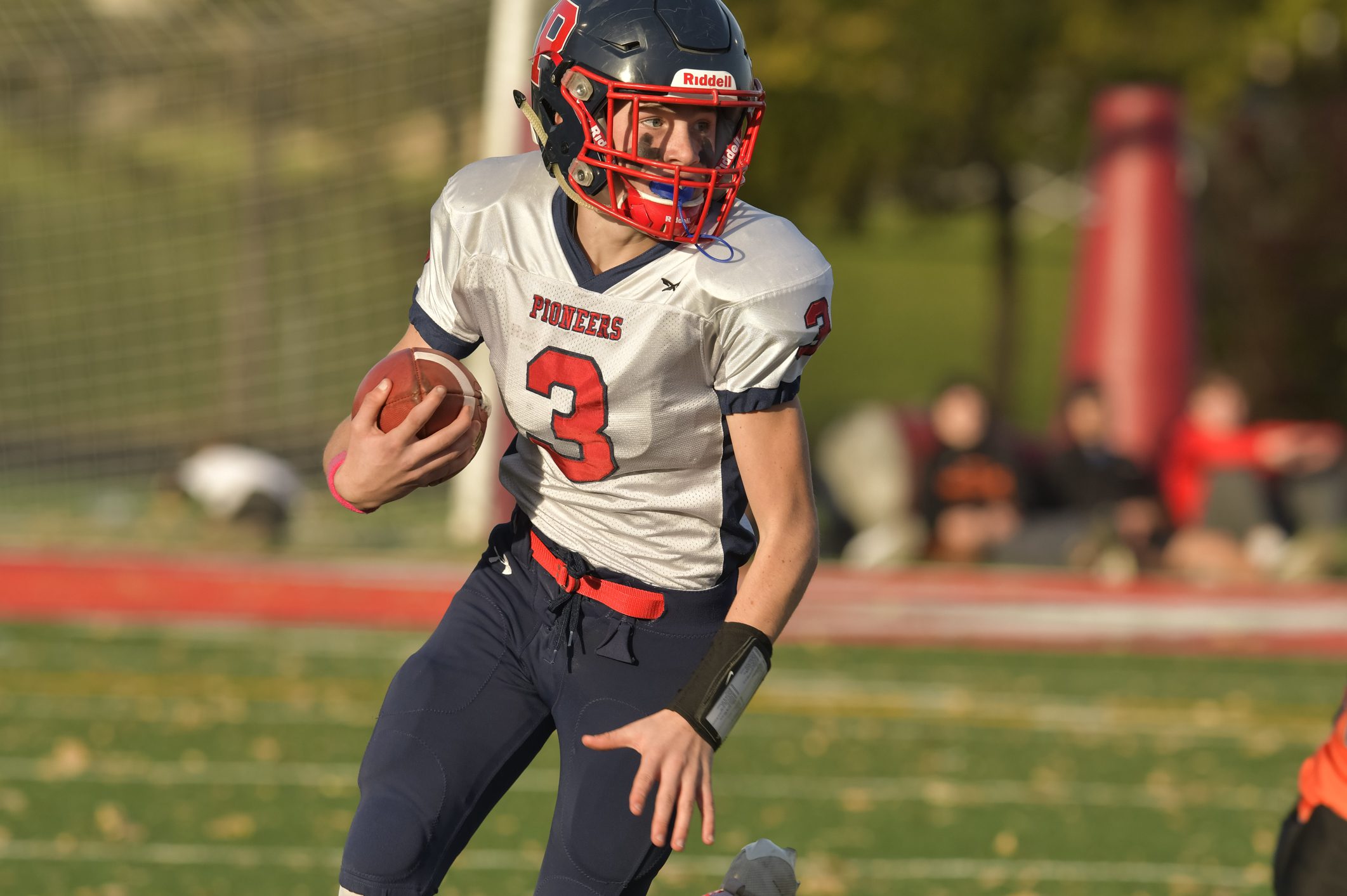 Football team's running back carries ball